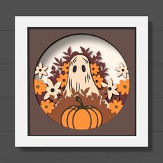 a paper cut out of a ghost surrounded by flowers and pumpkins