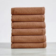 six brown towels stacked on top of each other