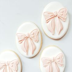 three decorated cookies with bows on them