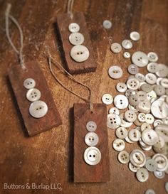 some buttons are laying on a wooden surface