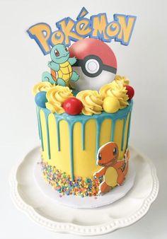 a pokemon themed cake with sprinkles and decorations on the top is sitting on a plate