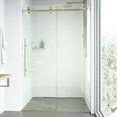 a bathroom with a glass shower door and white walls