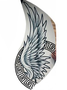 an artistically designed white and black surfboard with wings painted on it's side