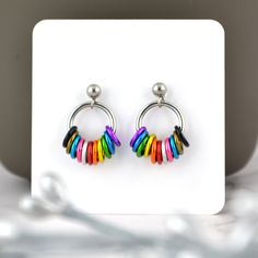 Comfortable post earrings in the vibrant colors of the lgbtq rainbow progress pride flag. These earrings are slightly larger than the minimalist tiny hoop earrings, designed specifically to accommodate the additional colors of the progress pride flag.🌈 earrings measure approximately 5/8" long from top of post🌈 aluminum and stainless steel links, and stainless steel ear postPROGRESS PRIDE colorway: black, brown, aqua, pink, white, red, orange, gold, green, blue, violet Rainbow Hypoallergenic Hoop Earrings, Hypoallergenic Rainbow Hoop Earrings, Nickel-free Small Hoop Rainbow Earrings, Adjustable Rainbow Small Hoop Earrings, Rainbow Small Hoop Earrings, Progress Pride Flag, Flag Earrings, Lgbtq Rainbow, Tiny Hoop Earrings