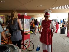 a woman in a red and white outfit standing next to a vending machine