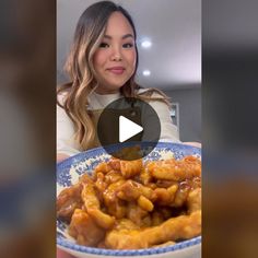 a woman sitting in front of a plate of food