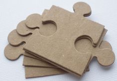 four pieces of cardboard are arranged in the shape of a jigsaw puzzle piece