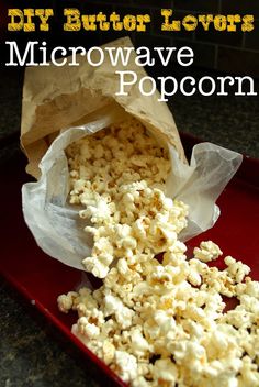 microwave popcorn sitting in a red tray with the words diy butter lover microwave popcorn