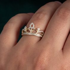 Band Width: 2mm Ring Height: 11.5mm Stone Type: Cubic Zirconia Stone Count: 59 Stone Shape: Round Stone Size: approx. 1mm - 1.2mm The Two-Tone Cubic Zirconia Filigree Crown Band Ring is a beautiful blend of elegance and regal charm. The intricate filigree design creates the appearance of a delicate crown, while the two-tone finish adds depth and a striking contrast to the piece. Sparkling cubic zirconia stones accentuate the graceful curves, bringing brilliance and sophistication to the design. Tiara Ring, Crown Royal, Tiaras And Crowns, Eye Drawing, Everyday Outfits, Tiara, Band Rings, Essence, Crown