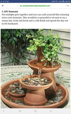 an image of a potted plant on top of a fountain with water running down it