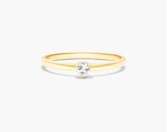 A timeless and classic piece of jewelry, this 1.8mm petite single white topaz birthstone ring in 14K yellow gold is a beautiful and elegant choice for any occasion. Made of high-quality gold and featuring a small, sparkling white topaz gemstone, this ring is a perfect way to show off your birthstone or add a touch of luxury to your everyday look. The ring is also available in a variety of other birthstones, so you can find the perfect one for your loved one. And because it is so petite, it can b Classic White Diamond Ring With Birthstone, Classic Yellow Gold Stackable Solitaire Rings, Classic Solitaire Yellow Gold Stackable Rings, Classic Stackable Yellow Gold Solitaire Rings, Timeless Yellow Gold Birthstone Ring With Diamond, Classic Diamond Ring With Birthstone In Round Band, Classic Yellow Gold Stackable Birthstone Ring, Classic Yellow Gold Birthstone Ring With Single Diamond, Classic Stackable Rings With Round Cut Birthstone