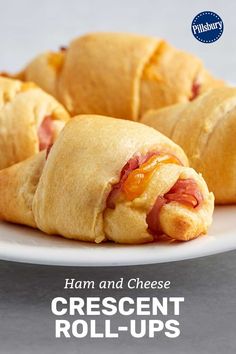 ham and cheese crescent rolls on a white plate with a blue border around the edges