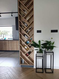 two planters sitting next to each other on top of a wooden floor