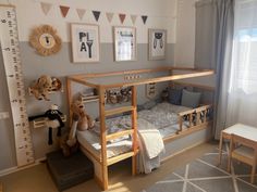 a child's bedroom with a bunk bed and stuffed animals on the floor next to it