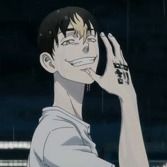 an anime character holding his hand up to his face with rain falling down on him