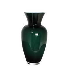 a dark green vase sitting on top of a white table