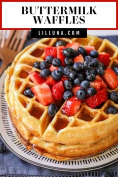 a waffle topped with strawberries and blueberries on top of a white plate