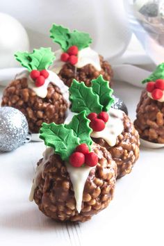 three christmas treats with holly decorations on them