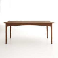 a wooden table sitting on top of a white floor