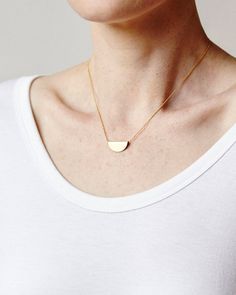 ◒ FELM - Brass half moon necklaceDETAILS AND FINISHINGS▴ Each piece is handmade.  Please expect slight variations between each item and the photograph in the listing.▴ Raw brass pendant is polished with a protective wax.▴ Chain is 24K gold plated brass.DIMENSIONS▴ Pendant Dimensions:  7/8" x 3/8"▴ Chain Length: 16" or 18"▴ Chain thickness: 1mm ball chainCARE▴ Handle with care and avoid striking against hard surfaces.▴ By nature, all brass will eventually darken over time but can be maintained an Everyday Half Moon Charm Necklace, Minimalist Jewelry With Moon Charm, Minimalist Crescent Charm Necklace With Clavicle Chain, Minimalist Crescent Clavicle Chain Charm Necklace, Minimalist Half Moon Necklace With Adjustable Chain, Elegant Everyday Half Moon Necklace, Minimalist Half Moon Clavicle Chain Necklace, Minimalist Jewelry With Adjustable Half Moon Chain, Everyday Crescent Necklace With Delicate Chain