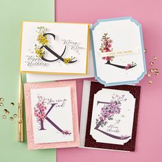 four greeting cards with flowers on them, one for each letter and the other for an initial