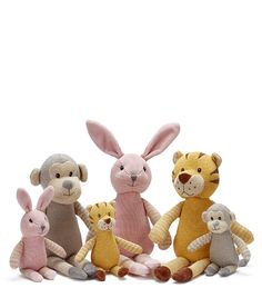 three stuffed animals are sitting next to each other in front of a white background,