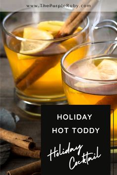 two glasses filled with hot toddy holiday cocktails and cinnamon sticks on the side