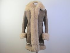 "Ready for a cold winter, here is a classic shearling \"Penny Lane\" style coat.  Made of genuine shearling with suede exterior, patch pockets, hook closures, clipped wool interior with long fuzzy shearling trim, the coat was most likely custom made as it doesn't have any labels.  It's in excellent condition without any stains or damage, only a tiny hint of exterior wear on the suede.  The size is a small.  I've included the measurements below allowing that the coat will go over other garments.  Bust 36\"-37\", Hips 41\", Length 35\", Sleeve length 22.5\", Back Shoulders (across shoulder blades) 14.75\"" Fitted Long Fur Coat For Cold Weather, Classic Sheepskin Fur Coat For Winter, Fitted Sheepskin Fur Coat For Winter, Fitted Shearling Fur Coat For Winter, Fitted Long Sheepskin Coat, Fitted Classic Sheepskin Fur Coat, Fitted Sheepskin Long Coat, Fitted Sheepskin Fur Coat, Classic Beige Fur Coat With Faux Fur Lining