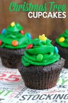 three chocolate cupcakes with green frosting and christmas trees on top are sitting on a table