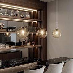 a modern bar with marble counter tops and hanging glass globe lights above the bar area