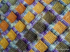 an orange and purple knitted blanket with squares