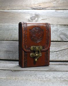 a brown leather case sitting on top of a wooden table