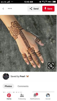 a hand with henna tattoos on it