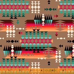 a ruler is next to a colorful pattern on a brown background with triangles and arrows