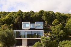 the house is surrounded by trees and bushes