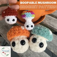 three crocheted stuffed animals sitting on top of a wooden table