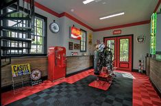 the inside of a motorcycle shop with red and black checkered flooring on the walls