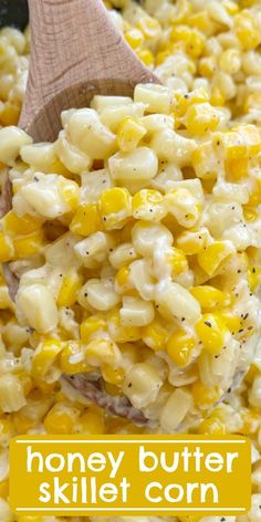 a wooden spoon in a bowl filled with macaroni and cheese on the side