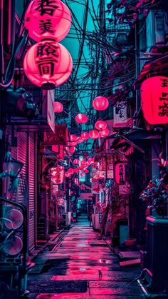 an alley way with red and pink lanterns hanging from it's sides in the dark