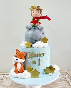 a birthday cake with a little boy on top