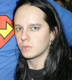 a woman with long black hair and piercings on her head is staring at the camera