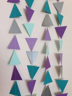 a wall hanging made out of paper with triangles