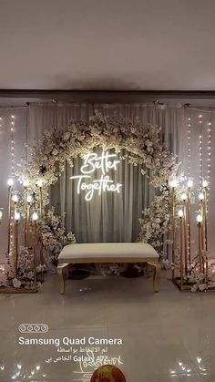 a white and gold wedding backdrop with lights