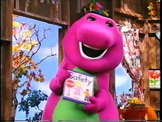 the pink dinosaur is standing in front of a store window and holding a sign that says,