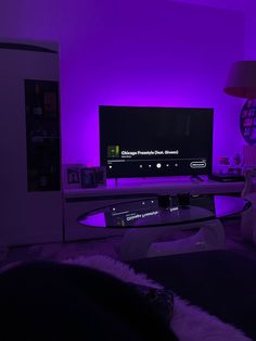 a living room with purple lighting and a flat screen tv