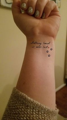 a woman's arm with a tattoo saying nothing loved is ever lost