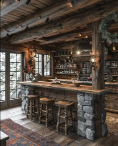 an old log cabin with stone bar and stools