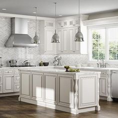 a kitchen with white cabinets and stainless steel appliances in the center, along with wooden floors