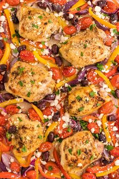 chicken, peppers and onions in a baking pan on a marble counter top with parsley