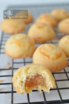 a muffin on a cooling rack with other muffins in the foreground